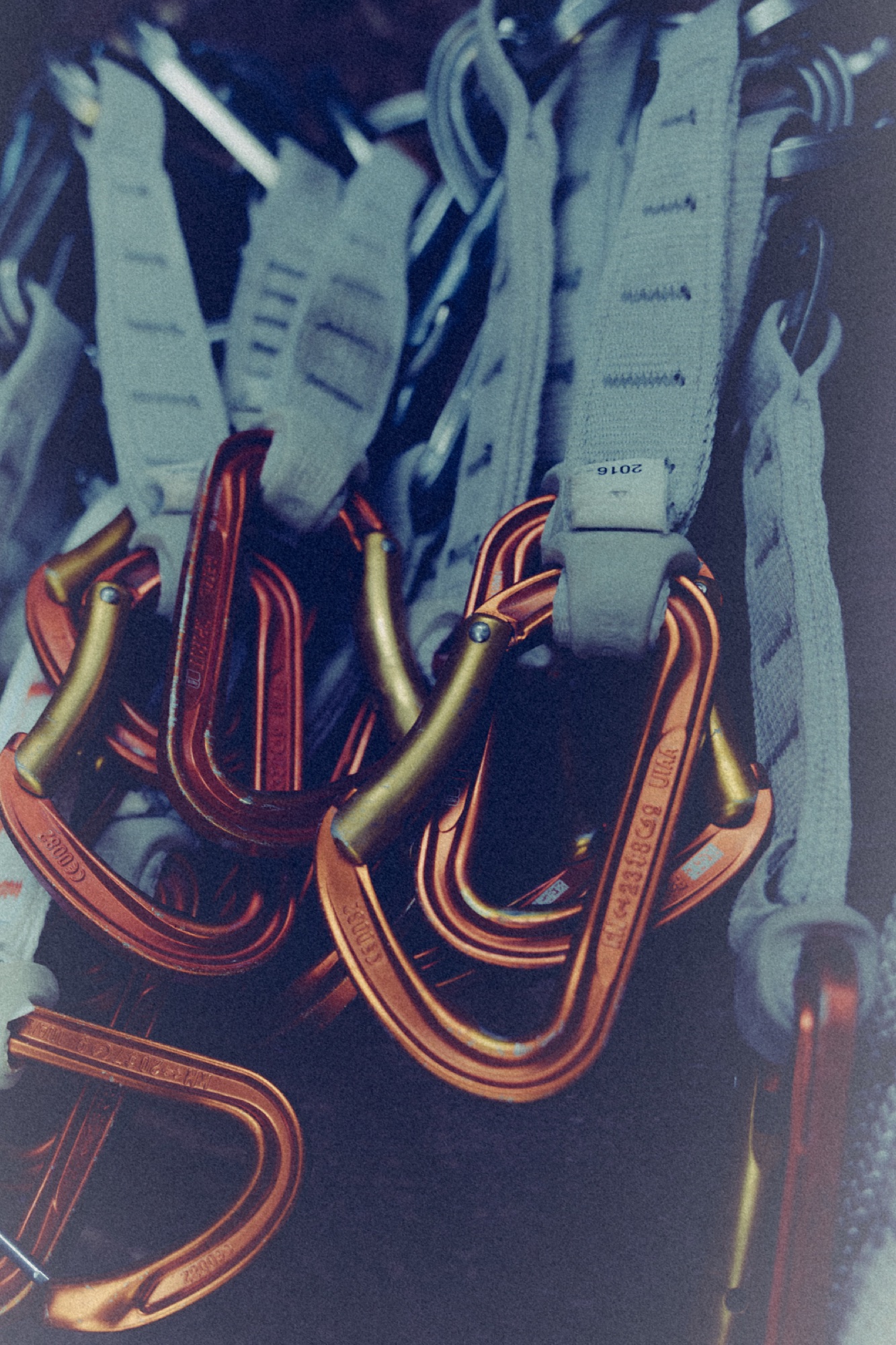 Orange climbing carabiners and slings photographed for the Arc’teryx ACA 2026 campaign