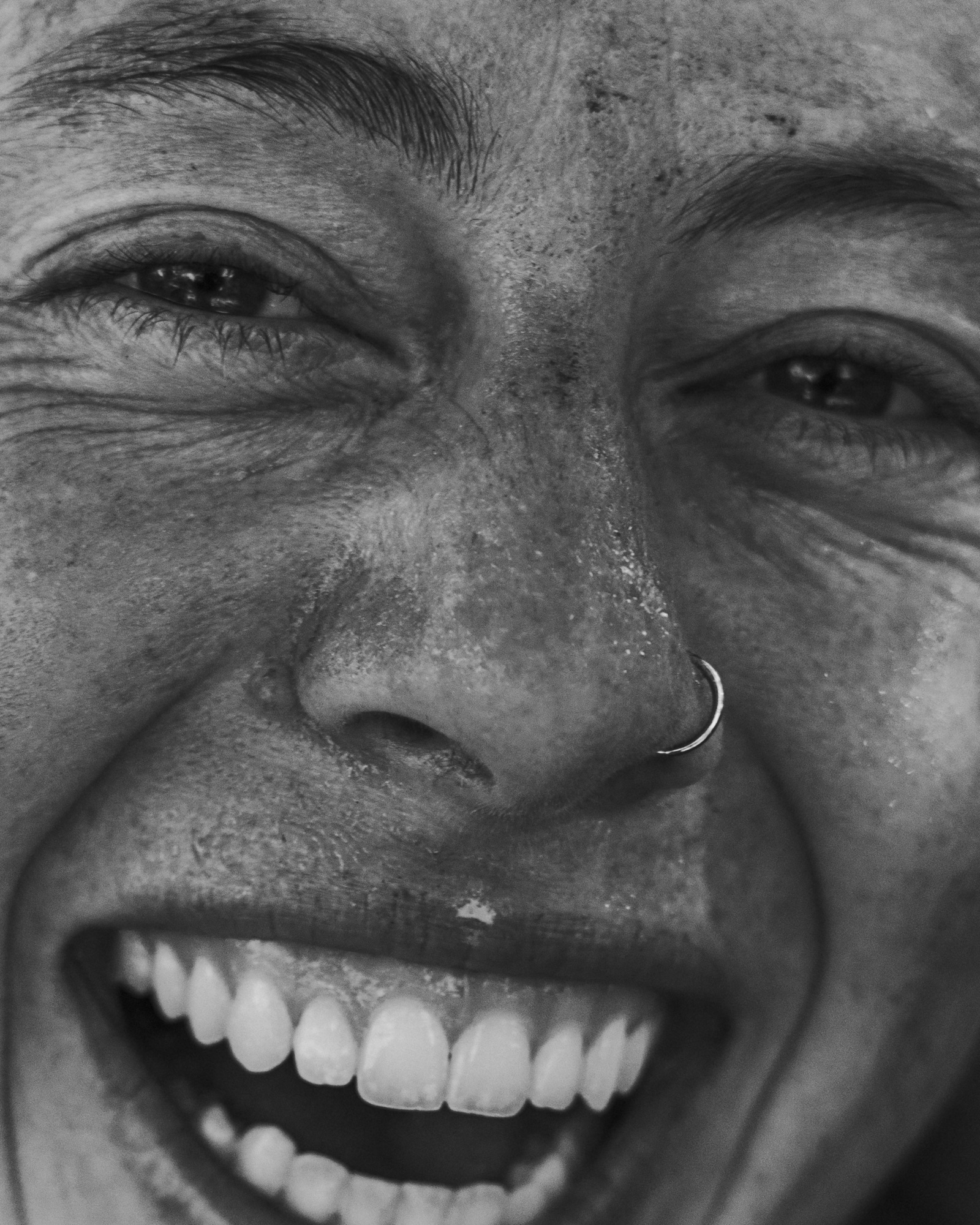 Black-and-white close portrait of a smiling climber